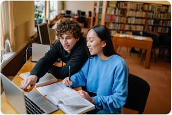 Two people working together at a computer.